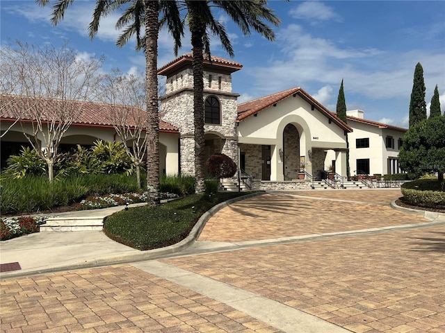 view of building exterior featuring decorative driveway