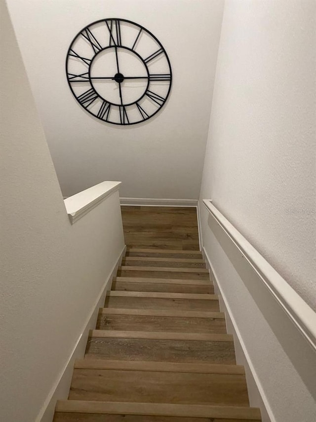 staircase featuring wood finished floors