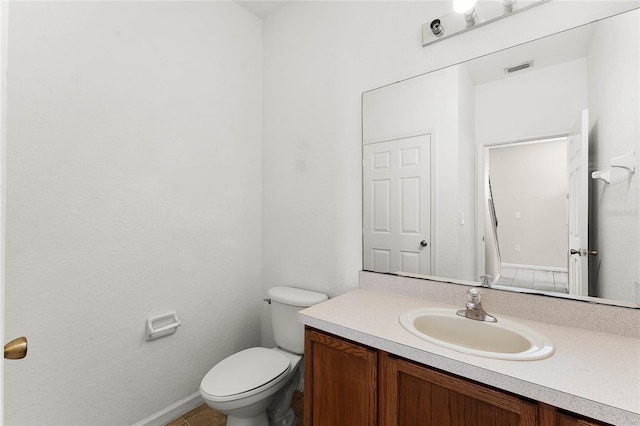 bathroom with visible vents, vanity, and toilet