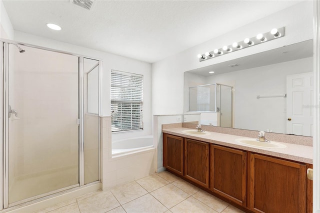 full bath featuring a stall shower, visible vents, a sink, tile patterned flooring, and a bath