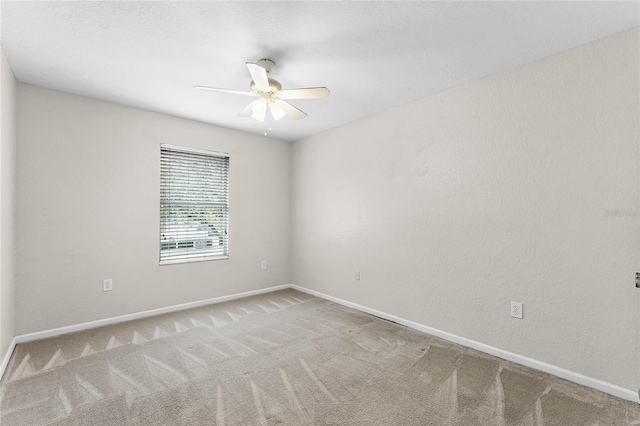 unfurnished room with carpet, baseboards, and ceiling fan