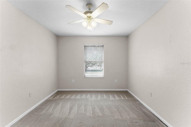 carpeted empty room featuring a textured ceiling, baseboards, a ceiling fan, and a textured wall