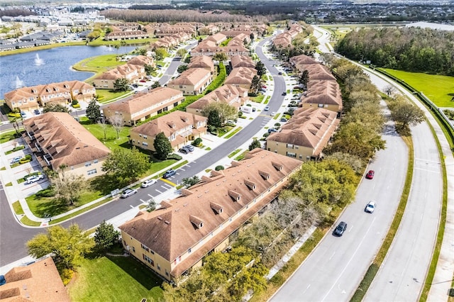 drone / aerial view with a water view and a residential view