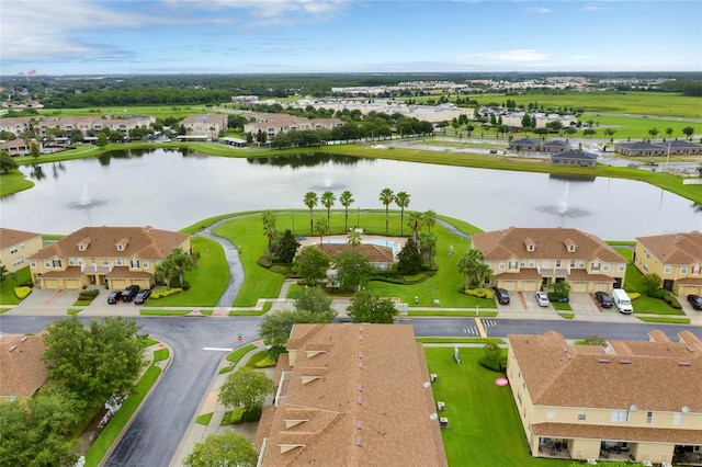 drone / aerial view with a water view and a residential view