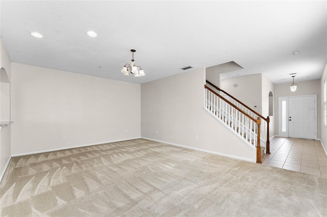 3102 Ashland Ln N Unit 3152, Kissimmee, FL 34741 - carpeted empty room featuring arched walkways, a chandelier, stairs, and recessed lighting
