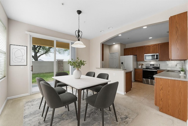 3102 Ashland Ln N Unit 3152, Kissimmee, FL 34741 - dining area with light carpet, recessed lighting, and arched walkways