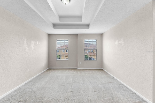 3102 Ashland Ln N Unit 3152, Kissimmee, FL 34741 - spare room featuring a textured wall, light carpet, a textured ceiling, and a raised ceiling