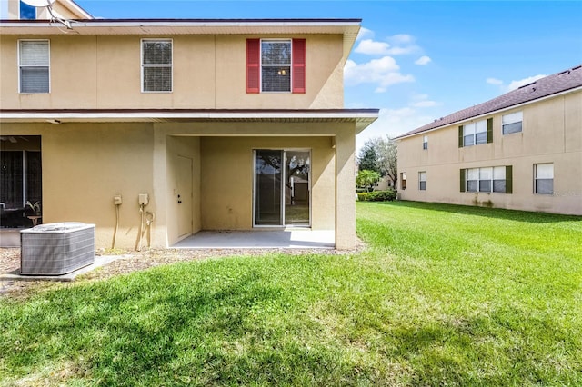 3102 Ashland Ln N Unit 3152, Kissimmee, FL 34741 - rear view of property with stucco siding, a patio area, and a lawn