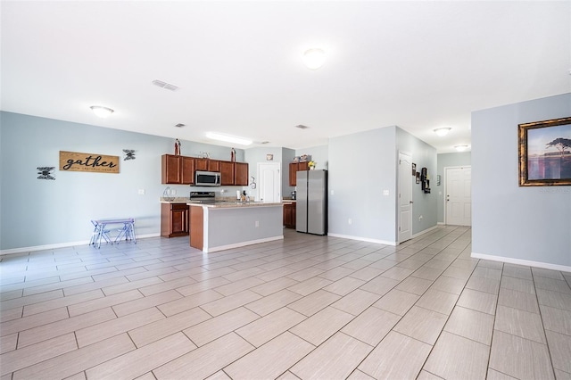 unfurnished living room featuring visible vents and baseboards