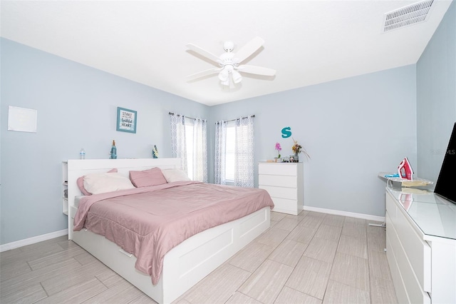 bedroom with baseboards, visible vents, and ceiling fan