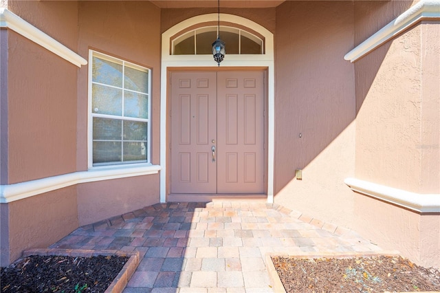 doorway to property with stucco siding