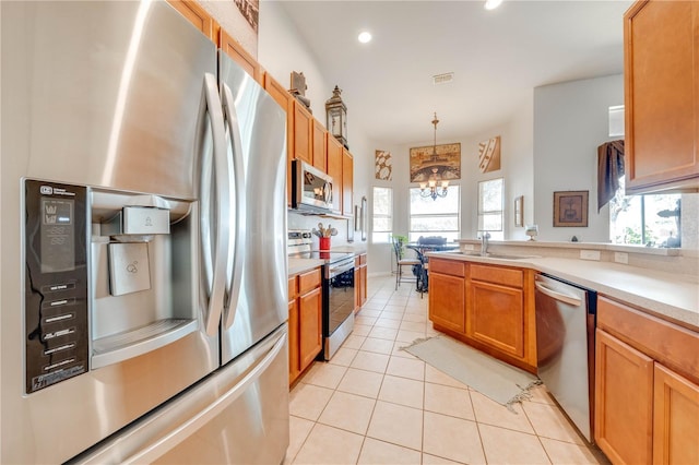 kitchen with stainless steel appliances, light countertops, visible vents, an inviting chandelier, and light tile patterned flooring