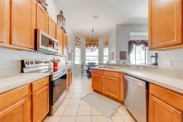 kitchen featuring light countertops, visible vents, appliances with stainless steel finishes, light tile patterned flooring, and a sink