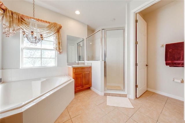 full bathroom with a chandelier, tile patterned flooring, vanity, a bath, and a stall shower