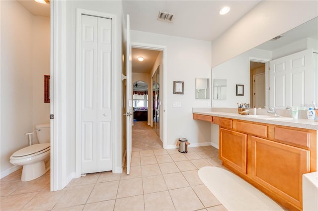 full bathroom with toilet, tile patterned flooring, visible vents, and a closet