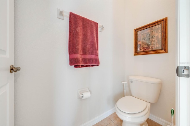 bathroom with toilet, tile patterned flooring, and baseboards