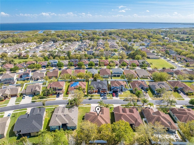 birds eye view of property with a residential view and a water view