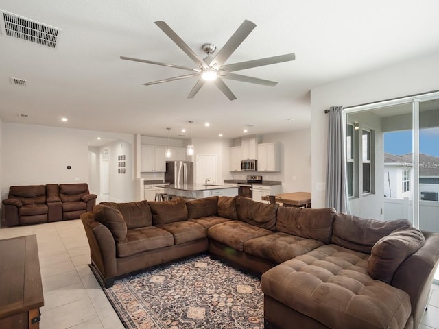 living area featuring recessed lighting, visible vents, ceiling fan, and light tile patterned flooring