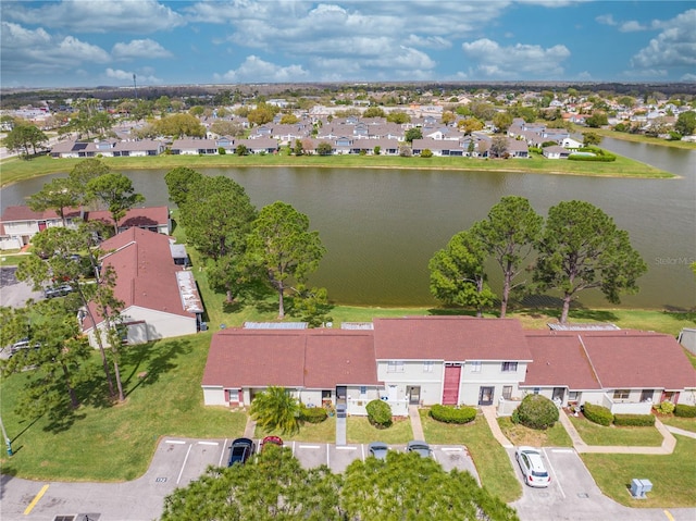 drone / aerial view featuring a residential view and a water view