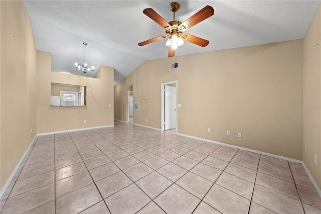unfurnished room featuring light tile patterned floors, lofted ceiling, a chandelier, a ceiling fan, and baseboards