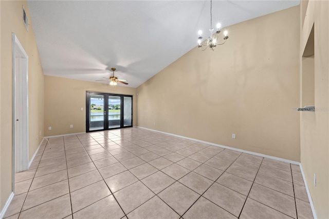 empty room with light tile patterned floors, a chandelier, a ceiling fan, baseboards, and vaulted ceiling