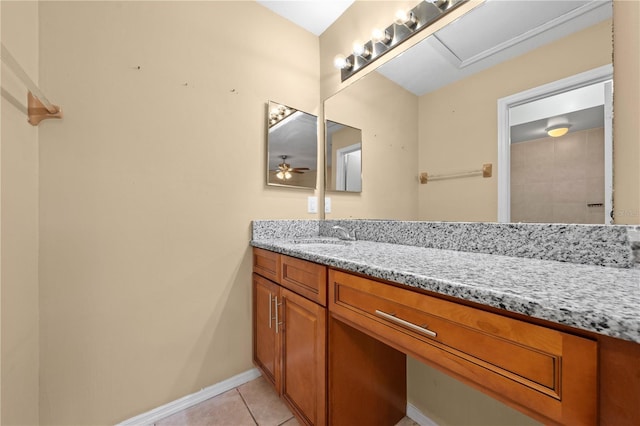 bathroom with tile patterned flooring, vanity, baseboards, and a ceiling fan