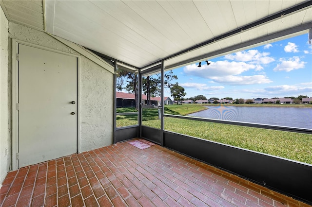 unfurnished sunroom with a water view