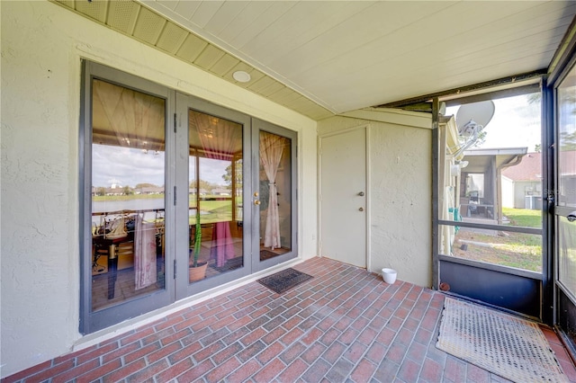 unfurnished sunroom featuring french doors