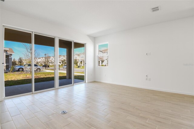 2985 Gavin Sky Dr, Kissimmee, FL 34744 - spare room with light wood finished floors, baseboards, and visible vents