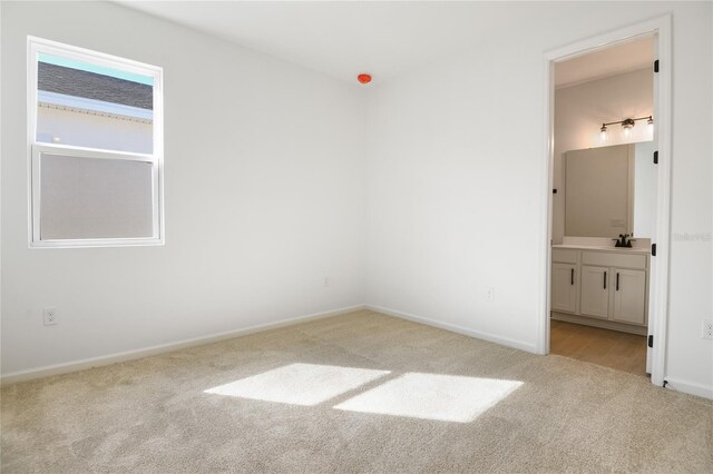 2985 Gavin Sky Dr, Kissimmee, FL 34744 - unfurnished bedroom featuring connected bathroom, baseboards, and carpet flooring