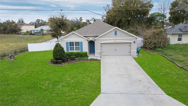 ranch-style house with driveway, a garage, a shingled roof, fence, and a front yard