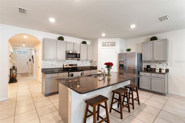 kitchen featuring appliances with stainless steel finishes, gray cabinets, and visible vents