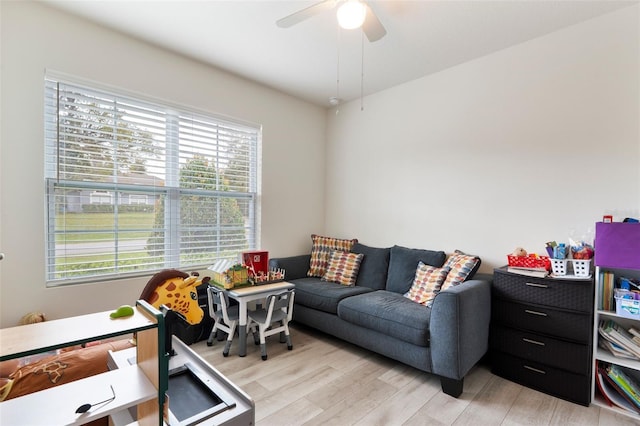 living area featuring ceiling fan and light wood finished floors