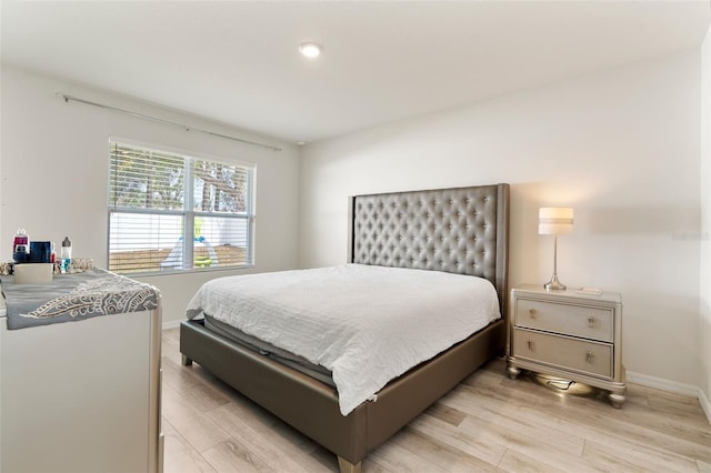 bedroom featuring light wood-type flooring and baseboards