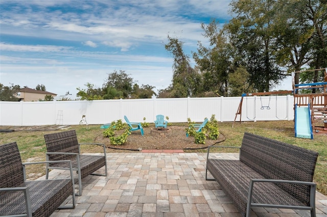 view of patio with a playground and a fenced backyard