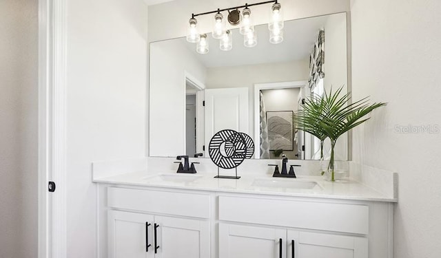 full bathroom with double vanity and a sink