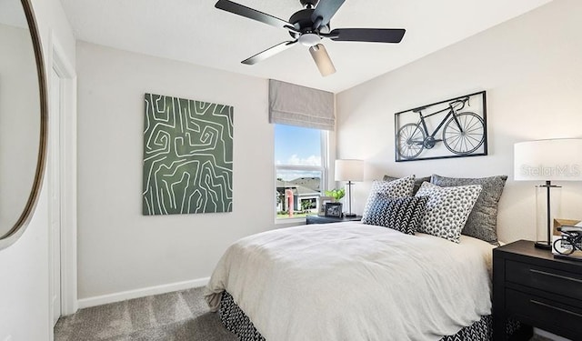 bedroom featuring ceiling fan, carpet, and baseboards