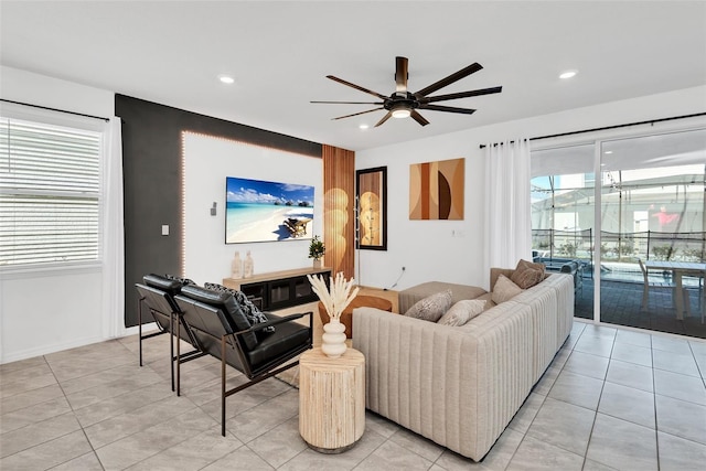 living room featuring recessed lighting, light tile patterned flooring, and a healthy amount of sunlight