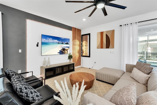 carpeted living area featuring a ceiling fan