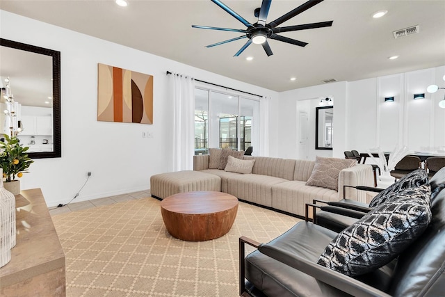 living room with light tile patterned floors, visible vents, and recessed lighting