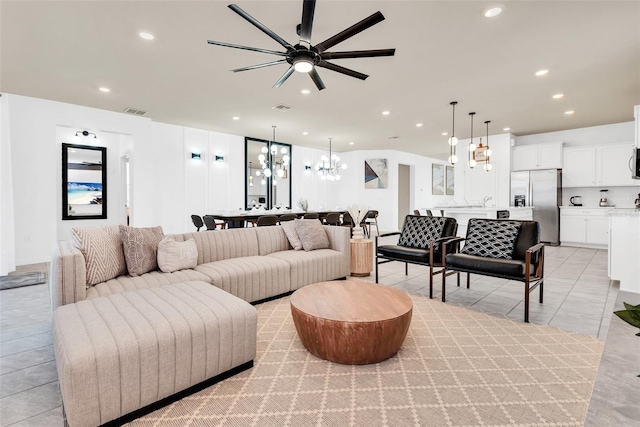 living room with light tile patterned floors, an inviting chandelier, visible vents, and recessed lighting