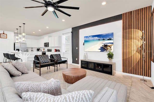 living area with ceiling fan, baseboards, and recessed lighting