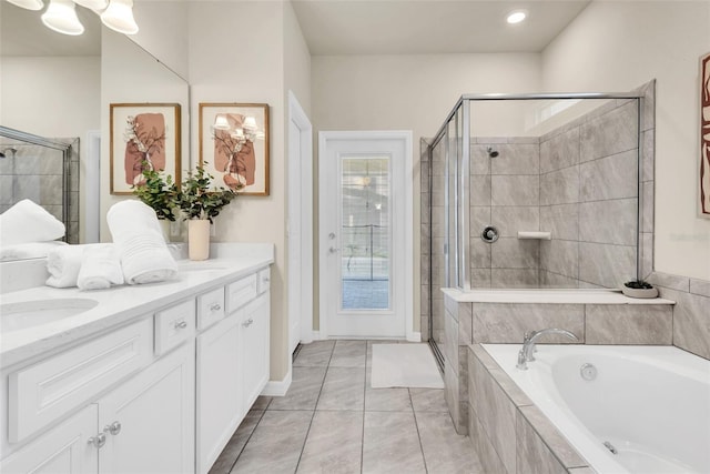 bathroom featuring vanity, a shower stall, a bath, and tile patterned floors