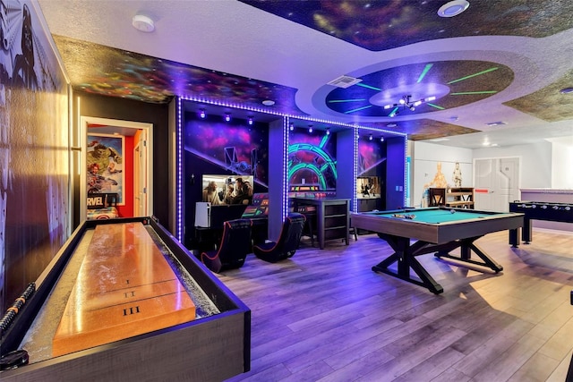 game room featuring visible vents, pool table, a dry bar, wood finished floors, and a textured ceiling