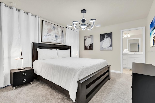 bedroom with light carpet, baseboards, ensuite bath, and an inviting chandelier