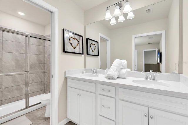 full bathroom featuring a sink, a shower stall, and toilet