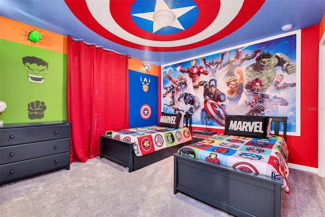 carpeted bedroom featuring a ceiling fan and a textured ceiling