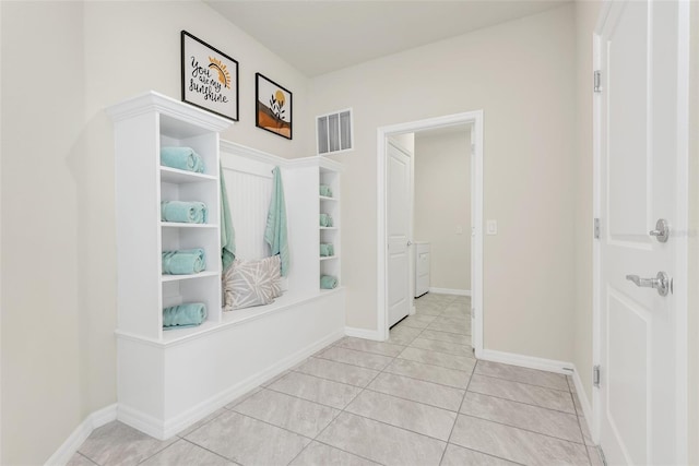 mudroom featuring light tile patterned flooring, visible vents, and baseboards