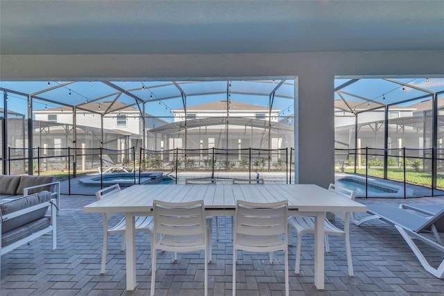 view of patio with a pool, glass enclosure, and an outdoor living space