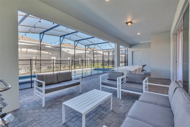 view of patio / terrace featuring a lanai, an outdoor living space, and a fenced in pool